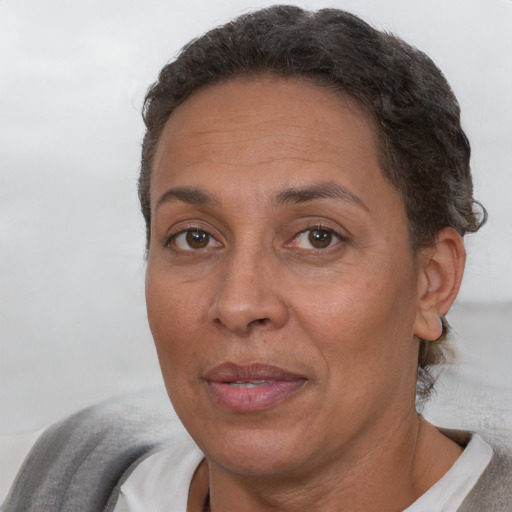 Joyful white adult female with short  brown hair and brown eyes