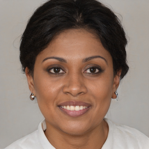 Joyful black young-adult female with medium  brown hair and brown eyes