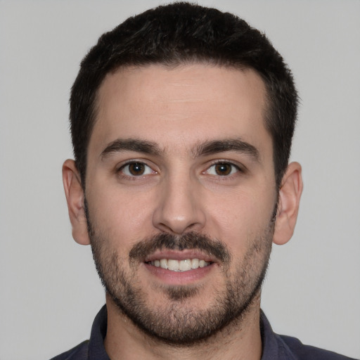 Joyful white young-adult male with short  black hair and brown eyes