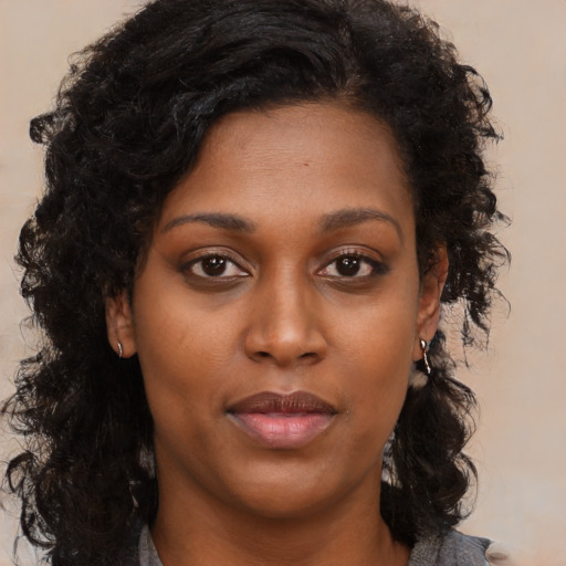 Neutral black young-adult female with long  brown hair and brown eyes
