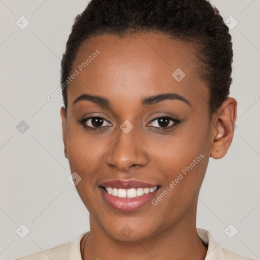 Joyful black young-adult female with short  brown hair and brown eyes