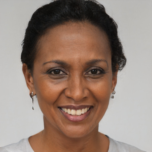 Joyful black adult female with short  brown hair and brown eyes