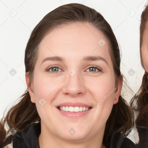 Joyful white young-adult female with long  brown hair and blue eyes