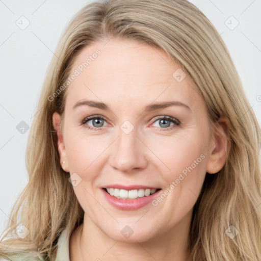 Joyful white young-adult female with long  brown hair and blue eyes