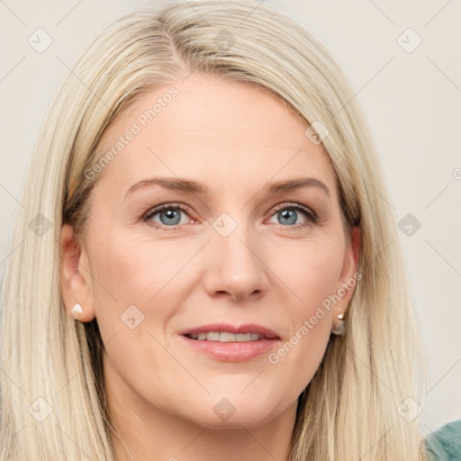 Joyful white adult female with long  brown hair and blue eyes