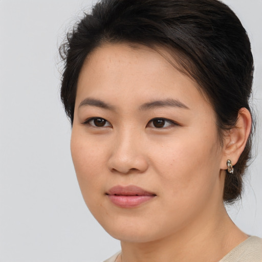 Joyful asian young-adult female with medium  brown hair and brown eyes