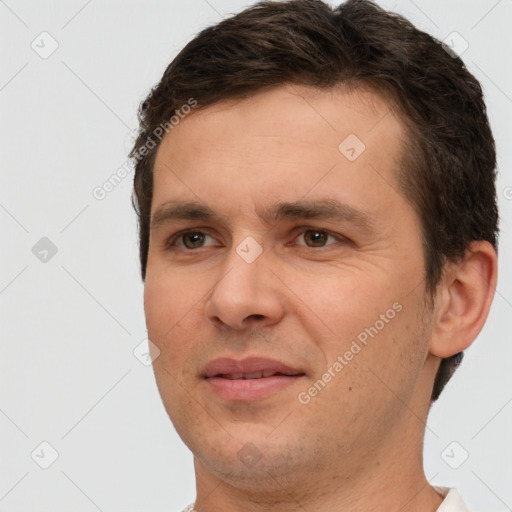 Joyful white adult male with short  brown hair and brown eyes