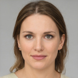 Joyful white young-adult female with medium  brown hair and green eyes