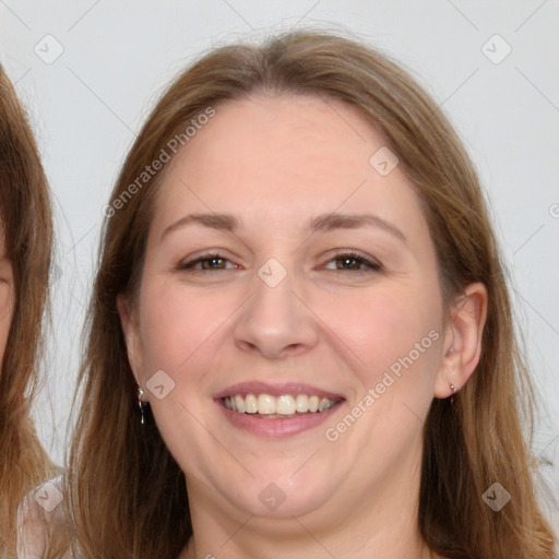 Joyful white adult female with long  brown hair and brown eyes