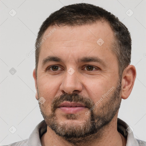 Joyful white adult male with short  brown hair and brown eyes