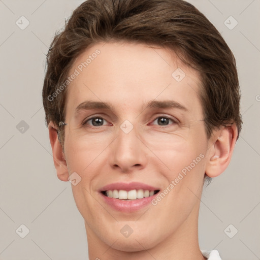 Joyful white young-adult female with short  brown hair and grey eyes