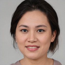 Joyful white young-adult female with medium  brown hair and brown eyes