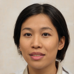 Joyful asian young-adult female with medium  brown hair and brown eyes