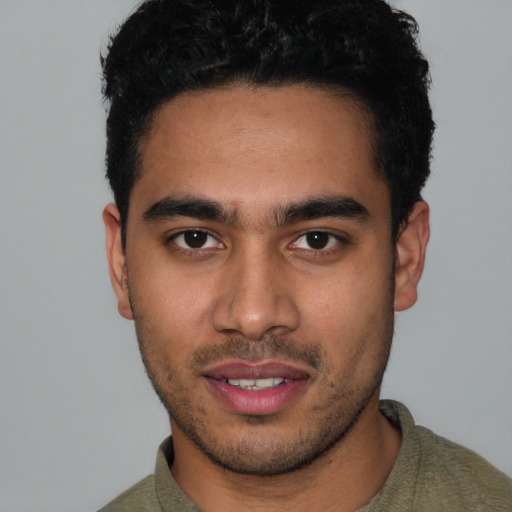 Joyful latino young-adult male with short  black hair and brown eyes