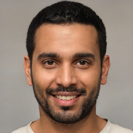 Joyful white young-adult male with short  black hair and brown eyes