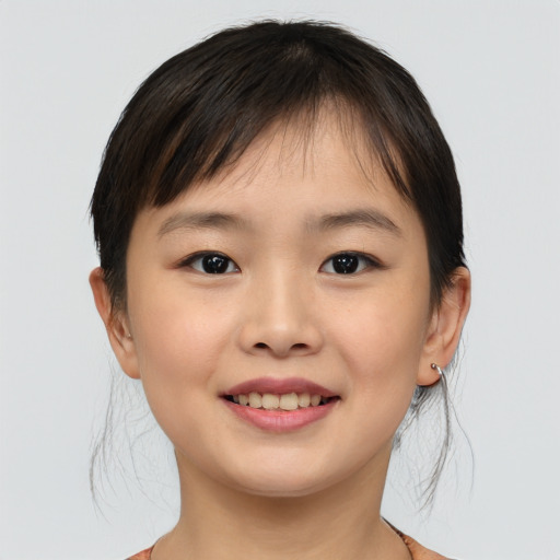 Joyful asian child female with short  brown hair and brown eyes