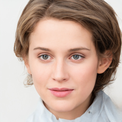 Joyful white young-adult female with medium  brown hair and green eyes