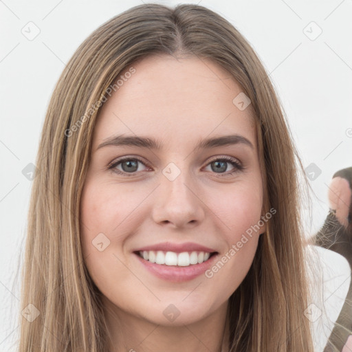 Joyful white young-adult female with long  brown hair and green eyes