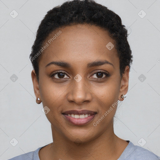 Joyful black young-adult female with short  black hair and brown eyes