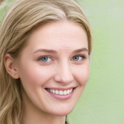 Joyful white young-adult female with long  brown hair and blue eyes