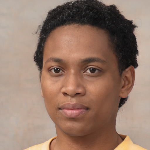 Joyful black young-adult male with short  brown hair and brown eyes