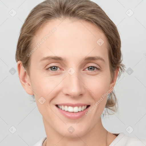 Joyful white young-adult female with medium  brown hair and grey eyes