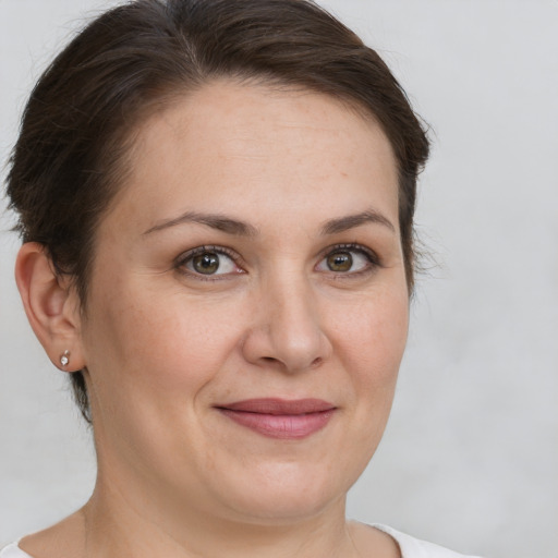 Joyful white adult female with short  brown hair and brown eyes