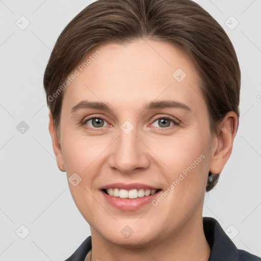 Joyful white young-adult female with short  brown hair and grey eyes