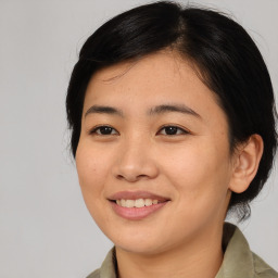 Joyful asian young-adult female with medium  black hair and brown eyes