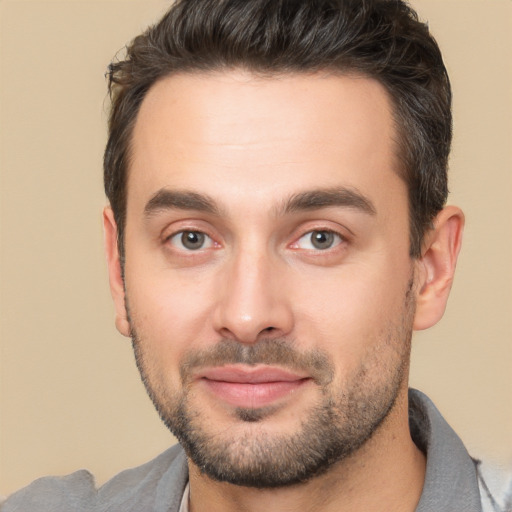 Joyful white young-adult male with short  brown hair and brown eyes