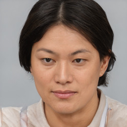 Joyful white adult female with medium  brown hair and brown eyes