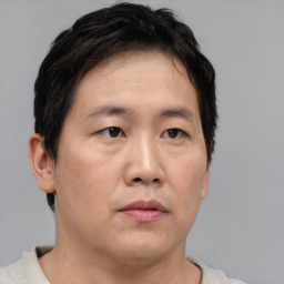 Neutral asian young-adult male with short  brown hair and brown eyes