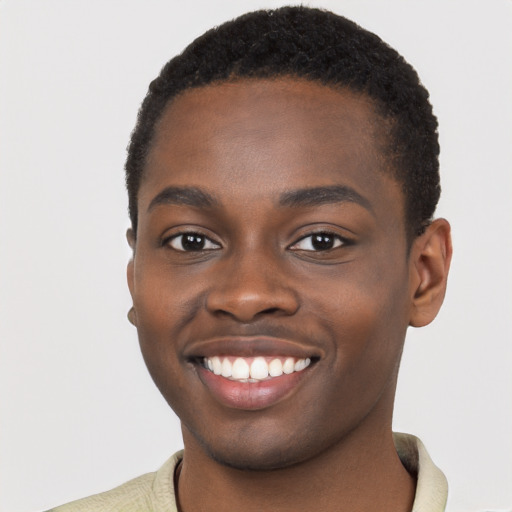 Joyful black young-adult male with short  brown hair and brown eyes