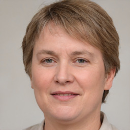 Joyful white adult female with medium  brown hair and grey eyes