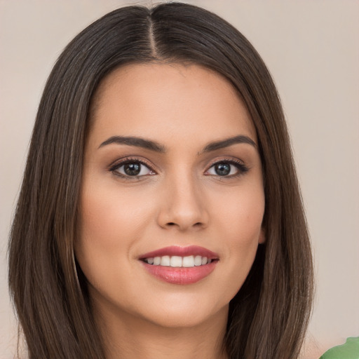 Joyful white young-adult female with long  brown hair and brown eyes