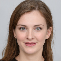 Joyful white young-adult female with long  brown hair and blue eyes