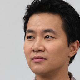 Joyful asian young-adult male with short  black hair and brown eyes