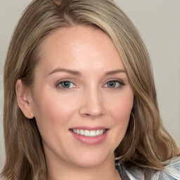 Joyful white young-adult female with medium  brown hair and blue eyes