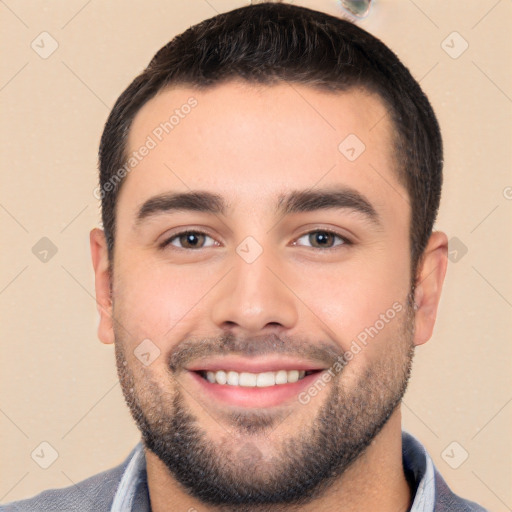 Joyful white young-adult male with short  black hair and brown eyes