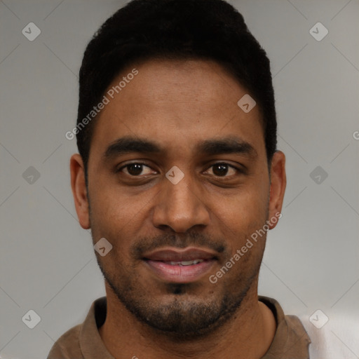Joyful black young-adult male with short  black hair and brown eyes