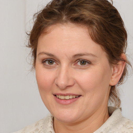 Joyful white adult female with medium  brown hair and brown eyes