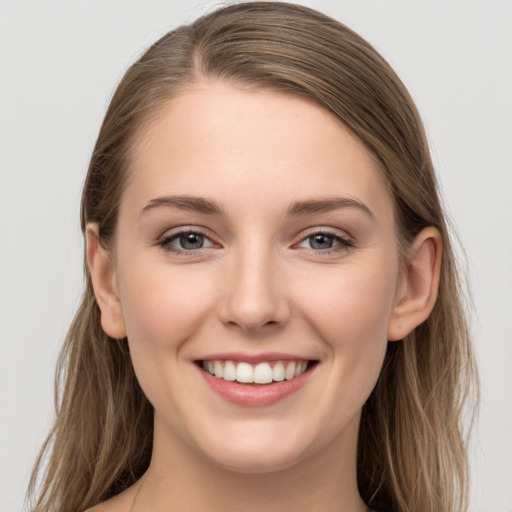 Joyful white young-adult female with long  brown hair and grey eyes