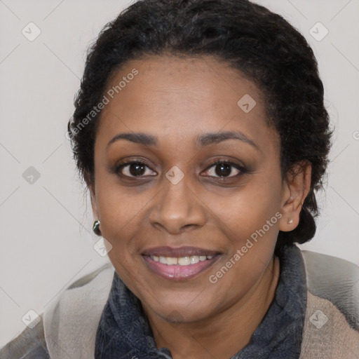 Joyful black adult female with medium  brown hair and brown eyes