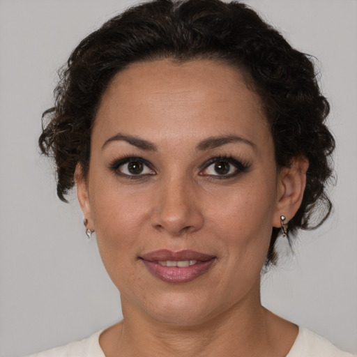 Joyful latino adult female with medium  brown hair and brown eyes