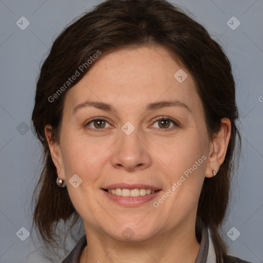 Joyful white adult female with medium  brown hair and brown eyes