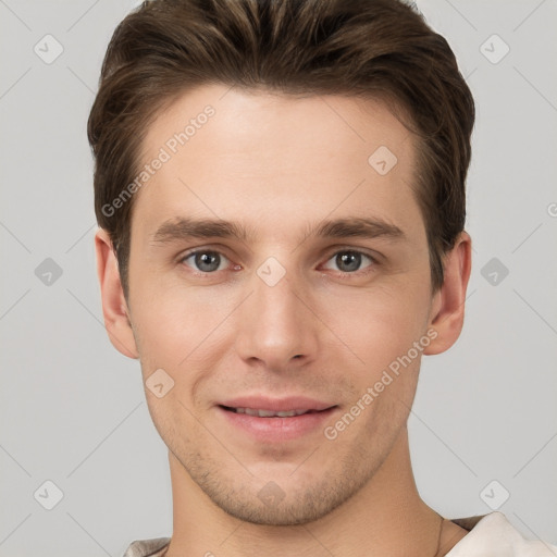 Joyful white young-adult male with short  brown hair and grey eyes