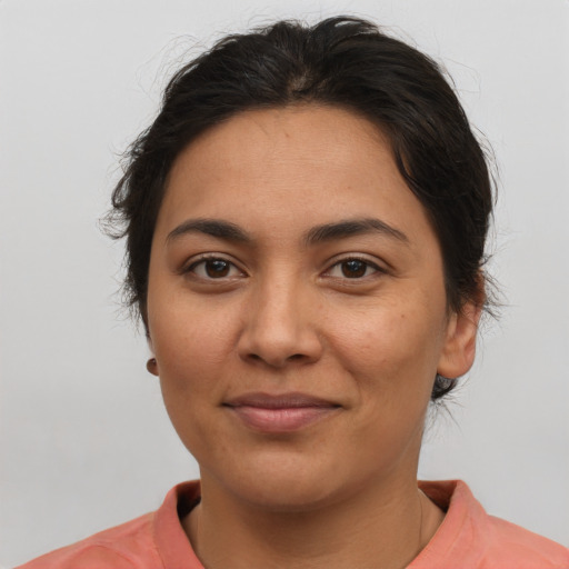 Joyful latino young-adult female with short  brown hair and brown eyes