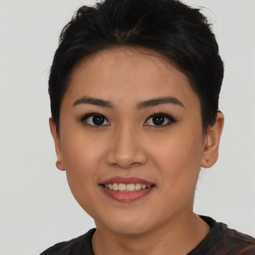 Joyful asian young-adult female with short  brown hair and brown eyes