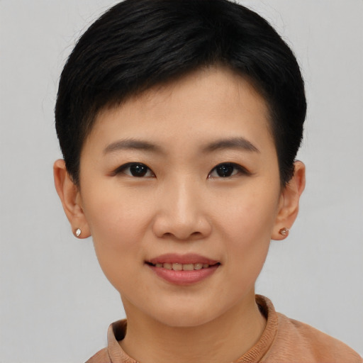 Joyful asian young-adult female with short  black hair and brown eyes