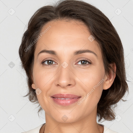 Joyful white adult female with medium  brown hair and brown eyes